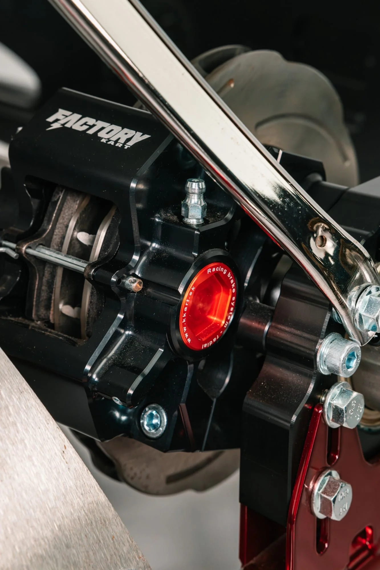 Factory Kart radial brake caliper with its red piston cap