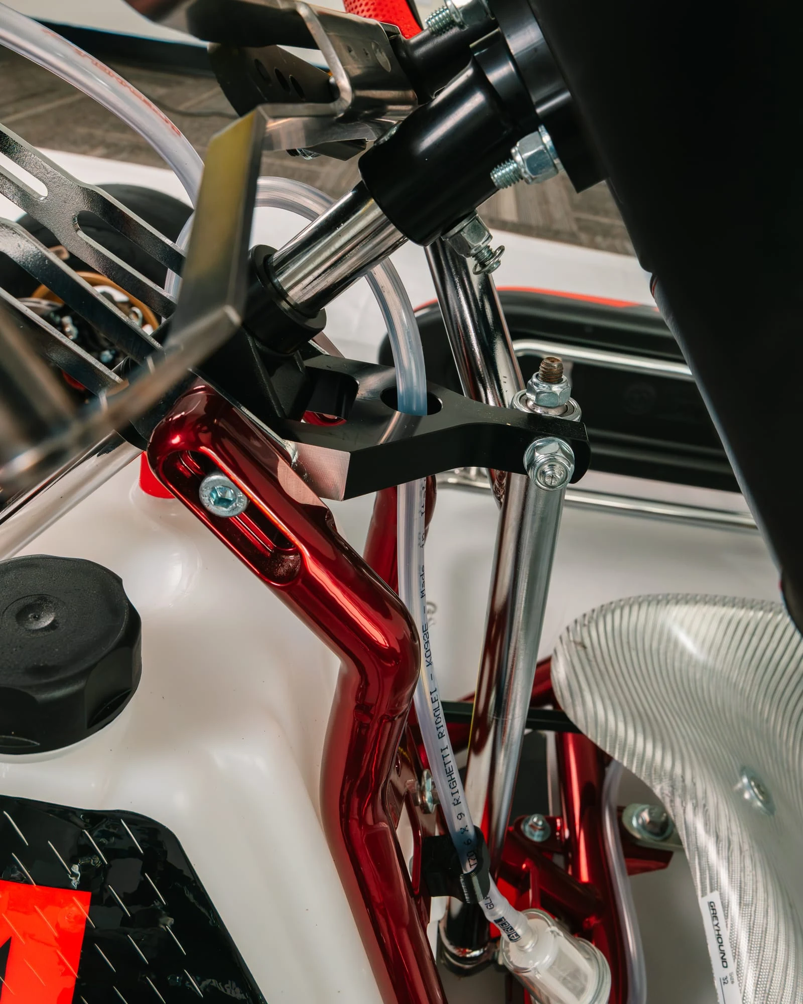 Steering column support bracket on the red chrome frame