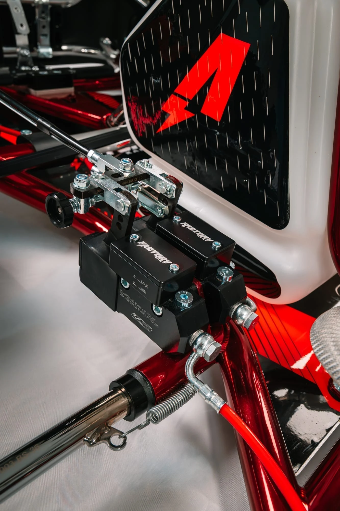 Twin master cylinders under the fuel tank